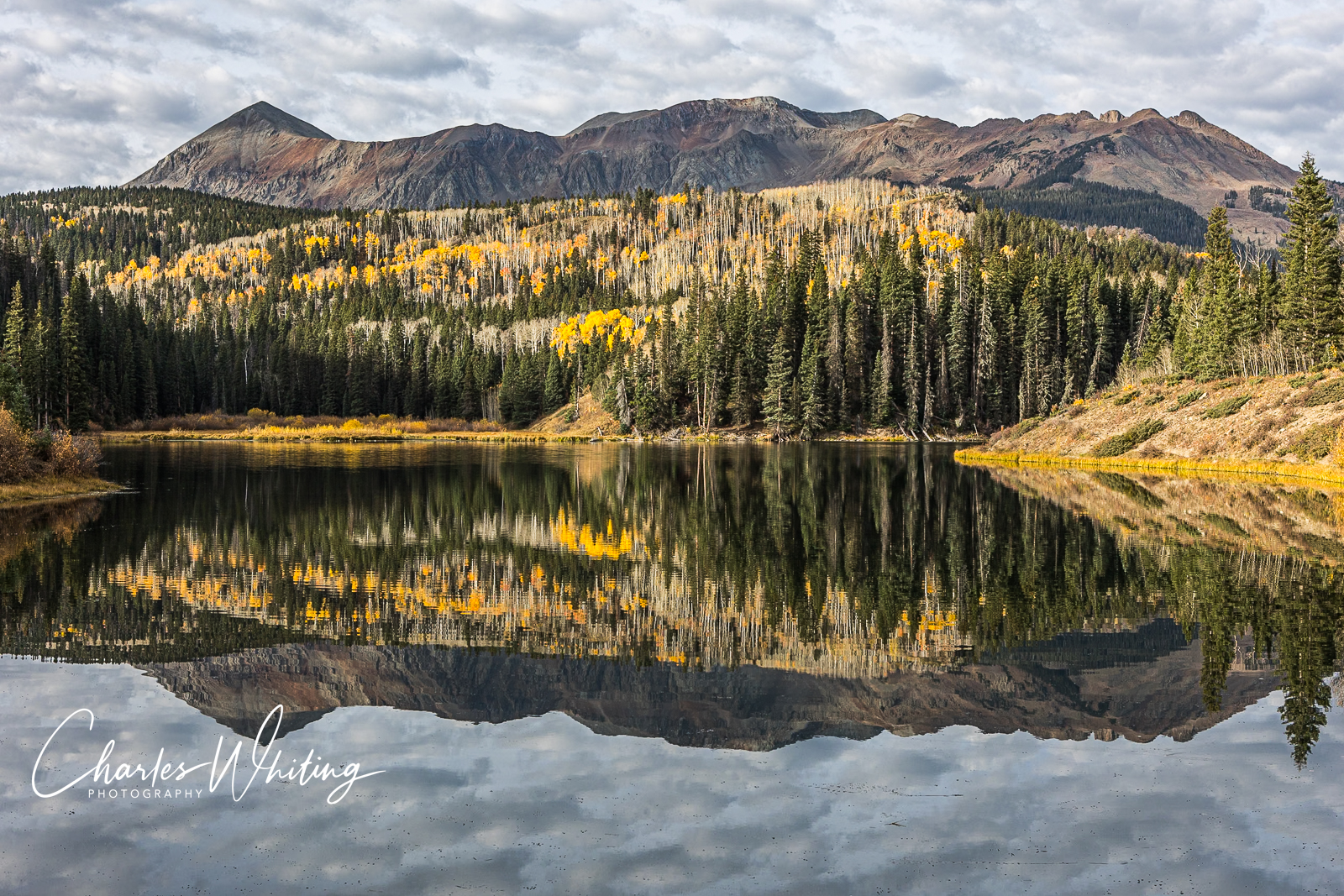 Dolores Peak reflects in the calm waters of Woods lake on a late fall day