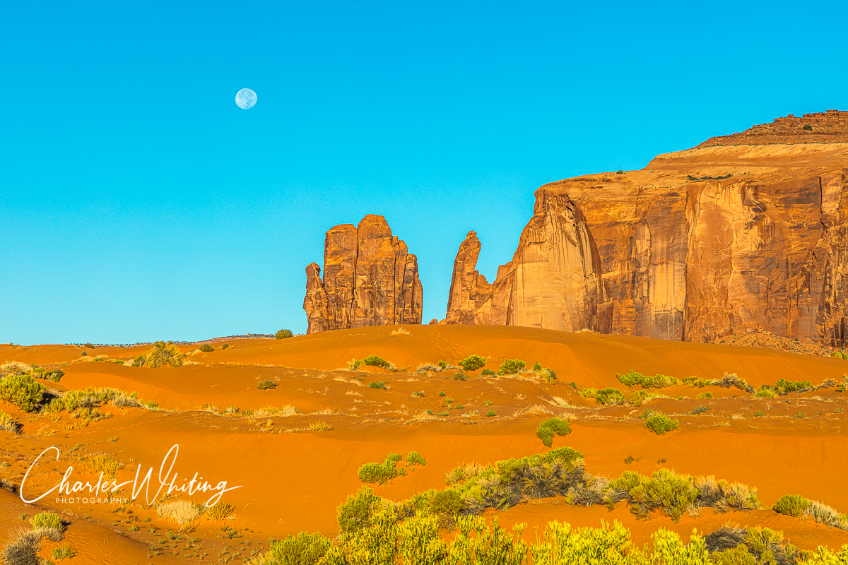 The setting full moon over the Hand of God, Monument Valley, Arizona