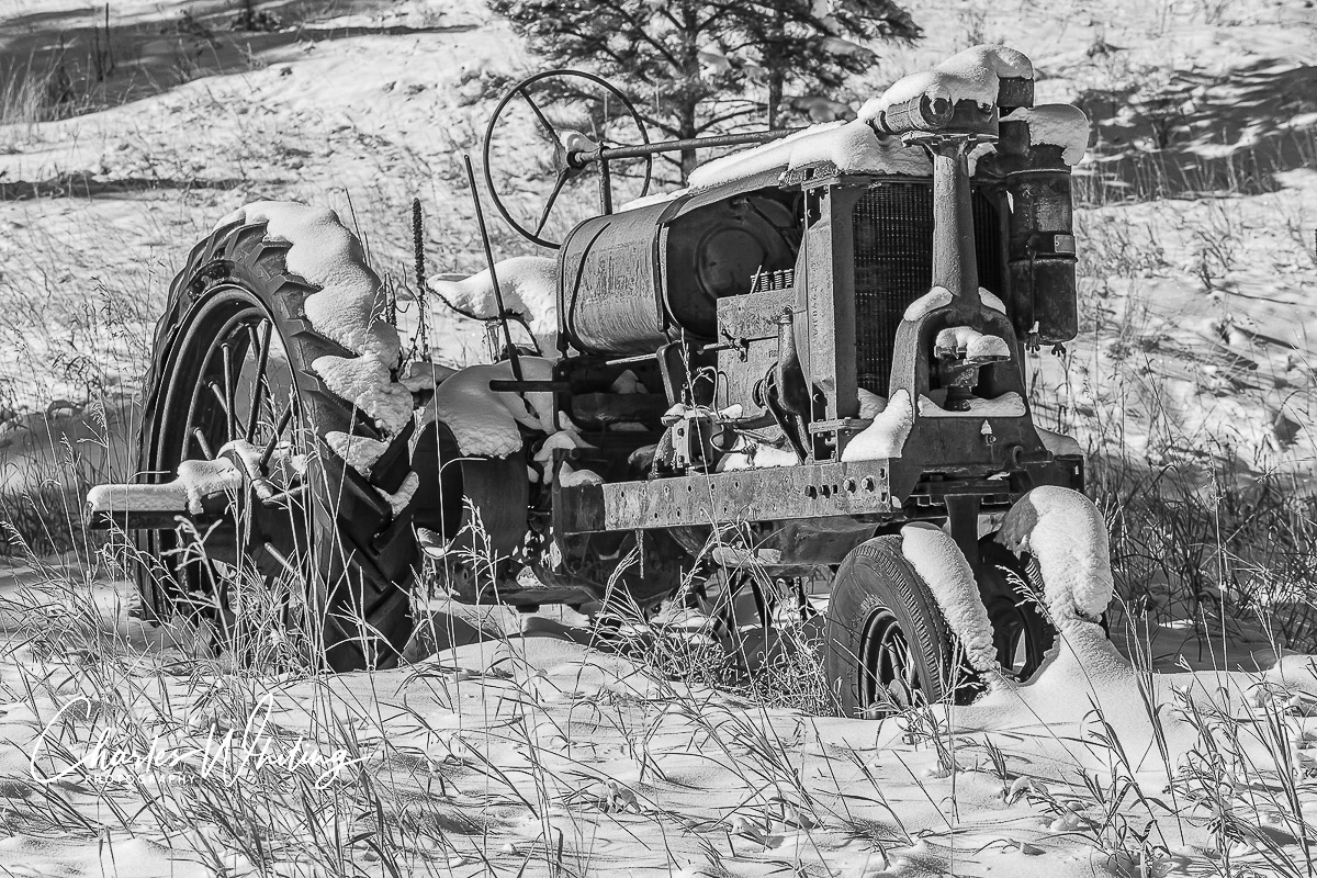 A black and white image of an old workhorse tractor