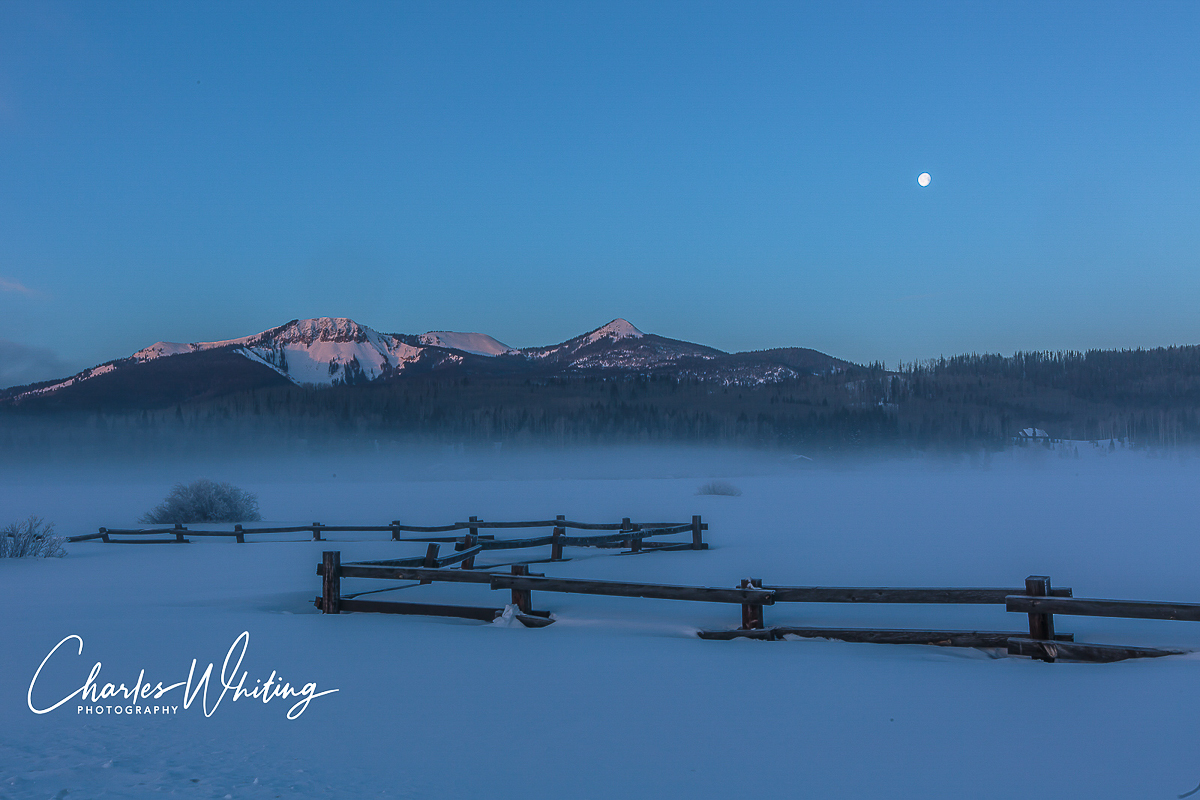 The first light of dawn paints the mountain peaks. Steamboat Springs, Colorado